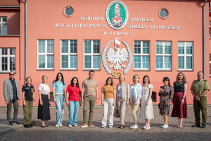 Zdjęcie grupowe przedstawicieli Państwowej Służby Migracyjnej Ukrainy, wykładowców, tłumacza przed budynkiem Ośodka