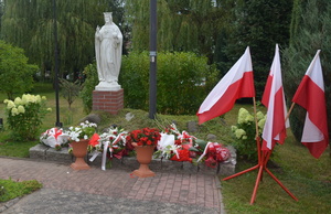 Wiązanki kwiatów przed Krzyżem Chrystusa Króla