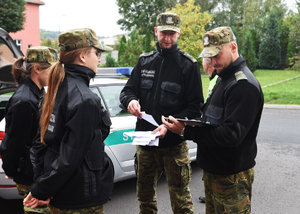 Komisja egzaminacyjna oraz dwie słuchaczki kursu podoficerskiego podczas egzaminu praktycznego Komisja egzaminacyjna oraz dwie słuchaczki kursu podoficerskiego podczas egzaminu praktycznego